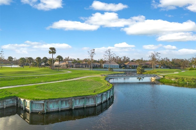 view of community featuring a water view and a yard