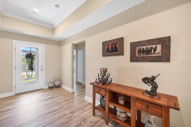 foyer entrance featuring light hardwood / wood-style floors and crown molding