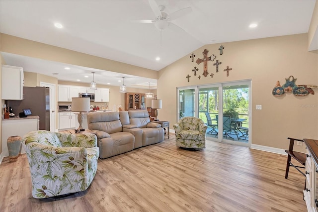 living room featuring light wood-type flooring, ceiling fan, and high vaulted ceiling