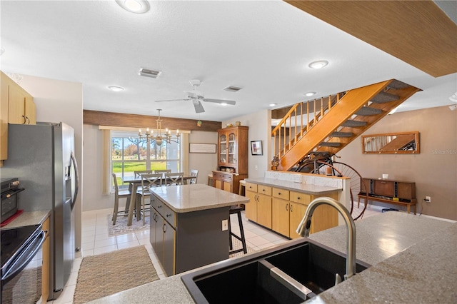 kitchen featuring a center island, decorative light fixtures, electric range, light tile patterned flooring, and a sink