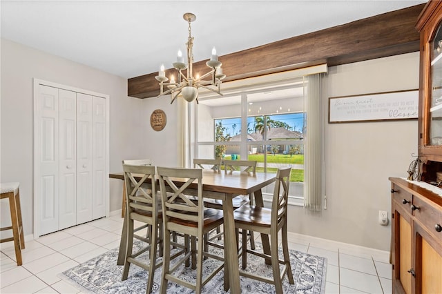 dining room featuring light tile patterned floors and a notable chandelier