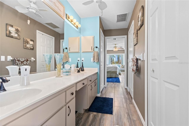 ensuite bathroom with double vanity, a closet, visible vents, a sink, and ensuite bath