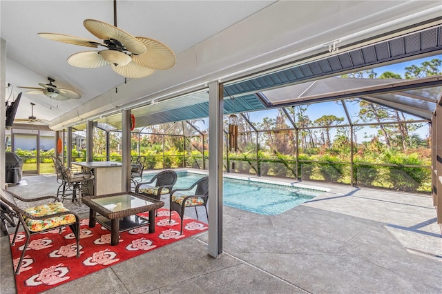 view of pool featuring glass enclosure, a grill, a patio area, and a bar