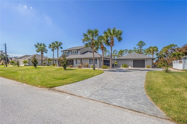 view of front facade with a garage and a front lawn