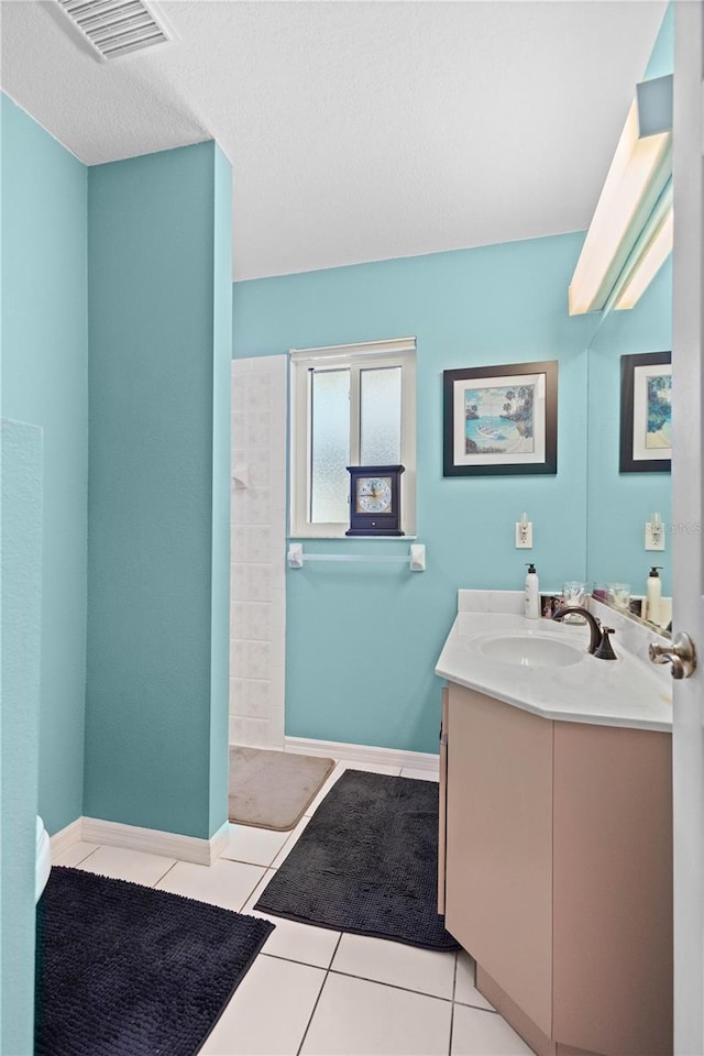 full bathroom with visible vents, tile patterned flooring, vanity, and baseboards