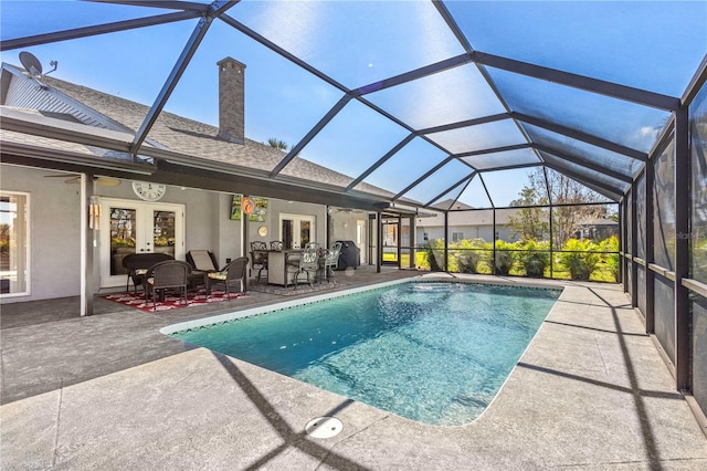 pool featuring a patio area, french doors, and glass enclosure