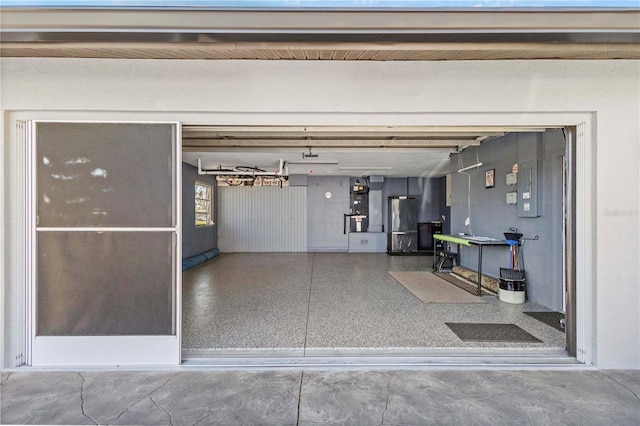 garage featuring freestanding refrigerator and heating unit