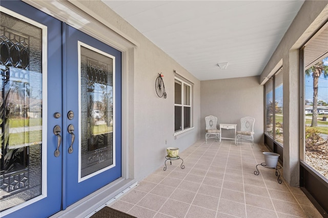 unfurnished sunroom featuring french doors