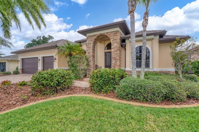 2517 Rio Grande Dr, Punta Gorda, FL 33950 - view of front of home with stucco siding, an attached garage, decorative driveway, and stone siding
