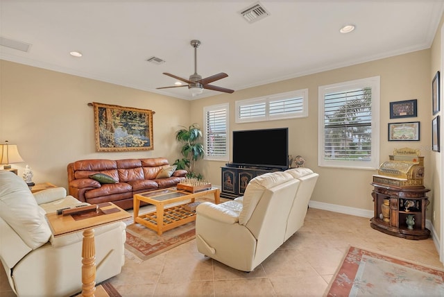 living room featuring ceiling fan, light tile patterned floors, ornamental molding, and a wealth of natural light