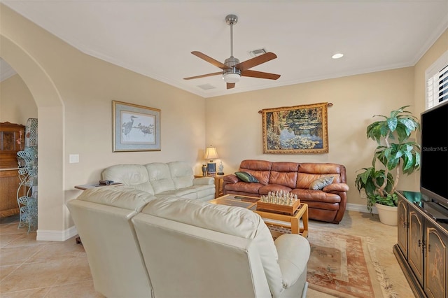 tiled living room with ceiling fan and ornamental molding