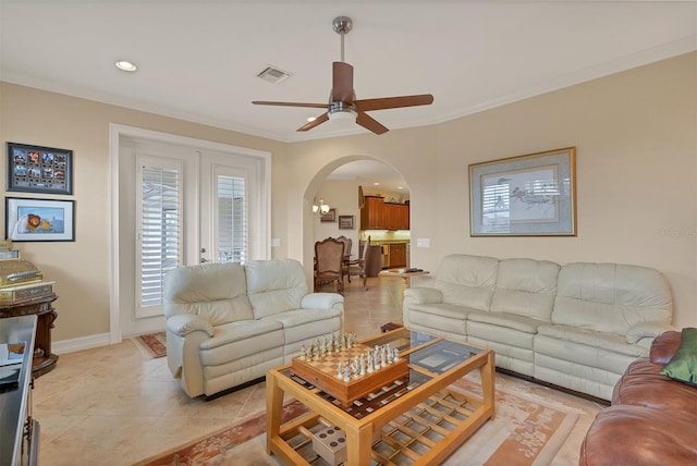 tiled living room featuring ceiling fan and ornamental molding