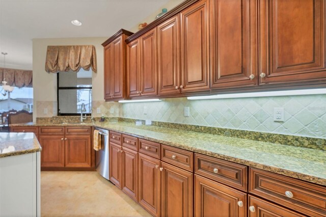 2517 Rio Grande Dr, Punta Gorda, FL 33950 - kitchen featuring dishwasher, light stone countertops, brown cabinetry, backsplash, and a sink