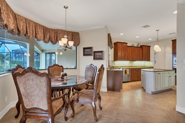 tiled dining space with a notable chandelier, crown molding, and sink