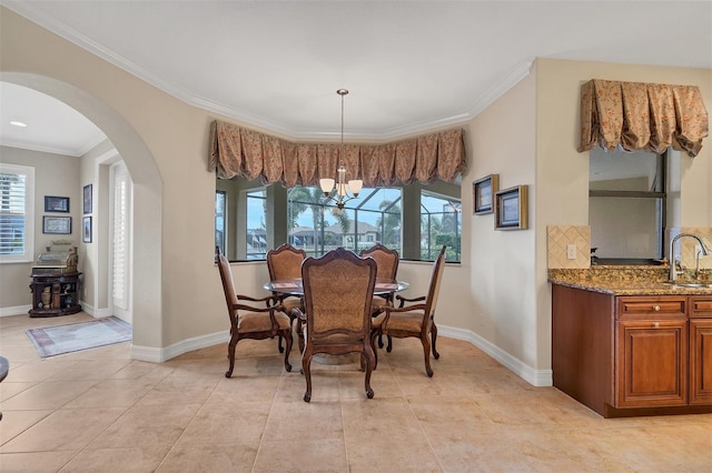 dining area with ornamental molding, sink, a chandelier, and light tile patterned flooring