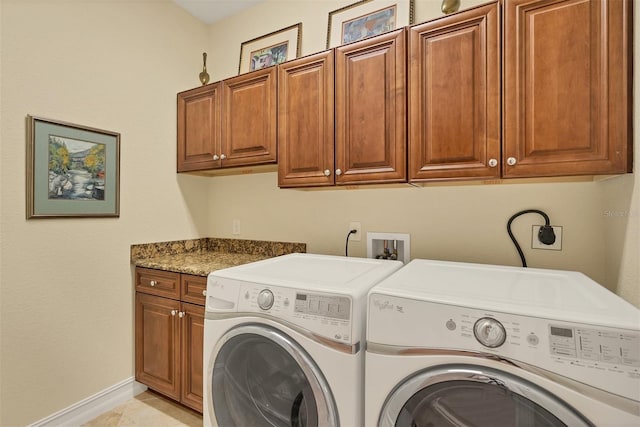 laundry room featuring separate washer and dryer, cabinets, and light tile patterned floors