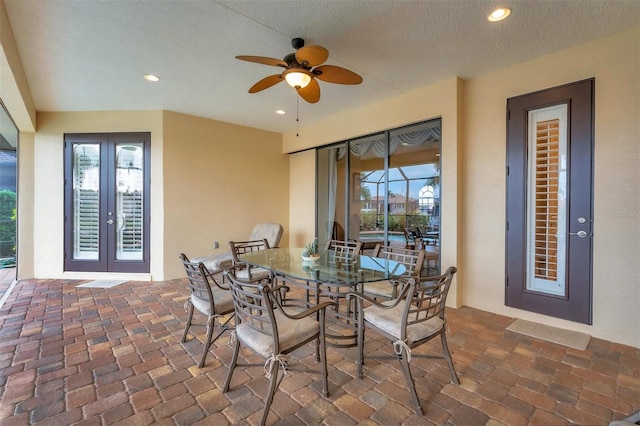 dining room with french doors, a textured ceiling, and ceiling fan