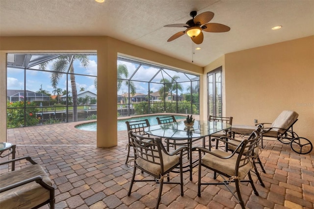 view of patio / terrace featuring a lanai and ceiling fan