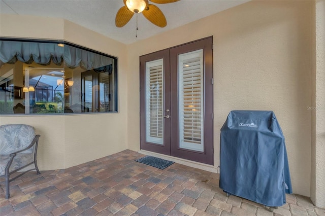 doorway to property with french doors, a patio, and ceiling fan