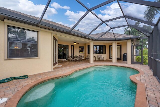 2517 Rio Grande Dr, Punta Gorda, FL 33950 - outdoor pool featuring a patio area, a ceiling fan, and glass enclosure
