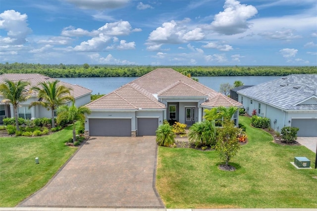 single story home with a front yard, a garage, and a water view