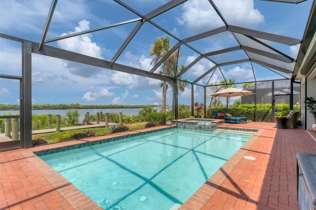 view of swimming pool featuring an in ground hot tub, a patio, glass enclosure, and a water view