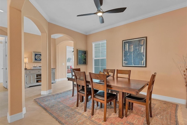 tiled dining room featuring ceiling fan and ornamental molding