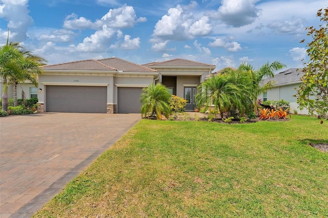 mediterranean / spanish-style home with a garage and a front yard