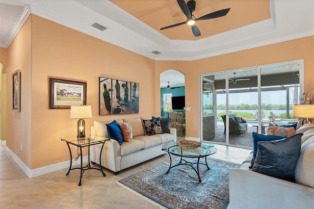 tiled living room featuring ceiling fan and crown molding