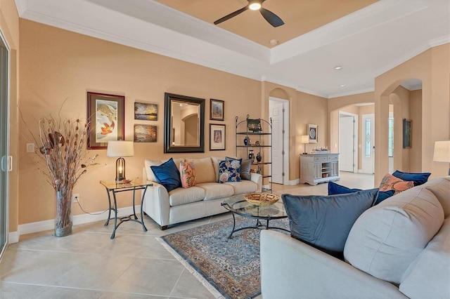 living room featuring ornamental molding, light tile patterned floors, and ceiling fan