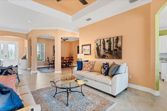 living room featuring ornamental molding, ceiling fan, and light tile patterned floors