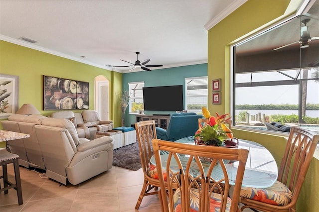 living room with ceiling fan, crown molding, and light tile patterned floors