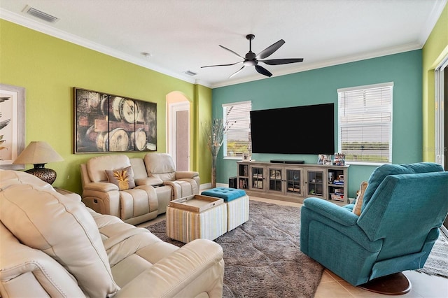 living room featuring ceiling fan, ornamental molding, and tile patterned floors