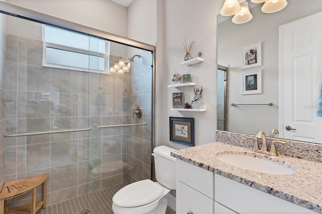 bathroom with vanity, toilet, and a shower with door