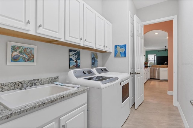 laundry room with light tile patterned flooring, cabinets, ceiling fan, washer and dryer, and sink