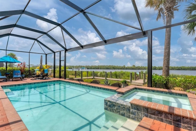 view of pool featuring a water view, glass enclosure, an in ground hot tub, and a patio area