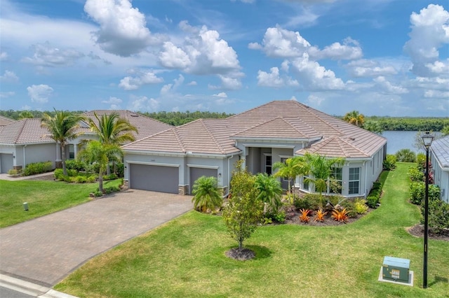 single story home featuring a garage and a front lawn