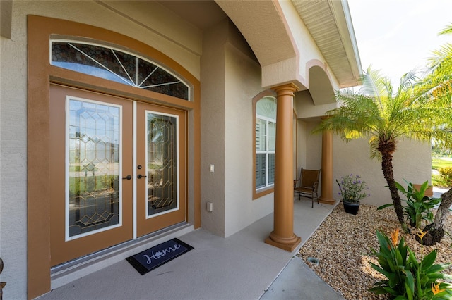 240 White Marsh Ln, Rotonda West, FL 33947 - doorway to property with stucco siding and french doors