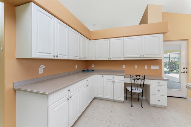 kitchen with white cabinetry and light tile patterned floors