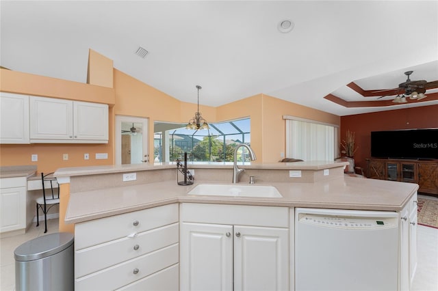 kitchen featuring sink, white dishwasher, vaulted ceiling, pendant lighting, and white cabinets