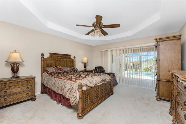 240 White Marsh Ln, Rotonda West, FL 33947 - bedroom featuring a tray ceiling, light colored carpet, access to outside, and ceiling fan