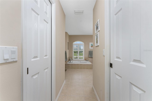 hallway with light tile patterned floors