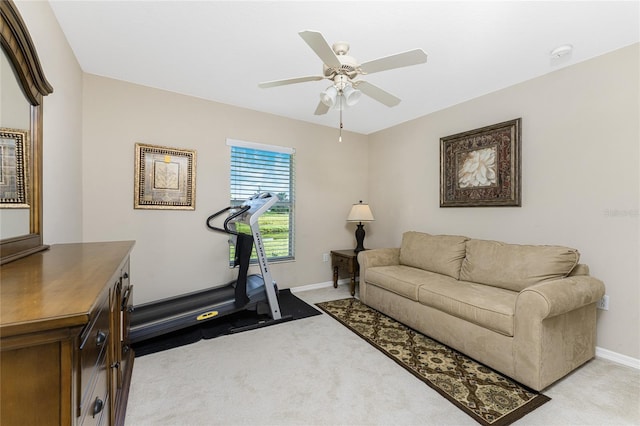 workout area with light carpet and ceiling fan