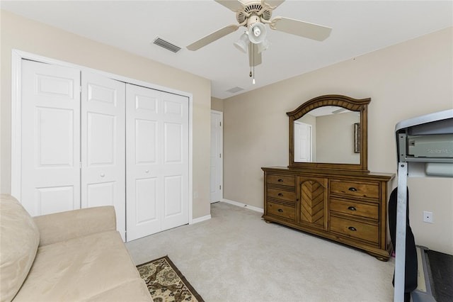 living area featuring light colored carpet and ceiling fan