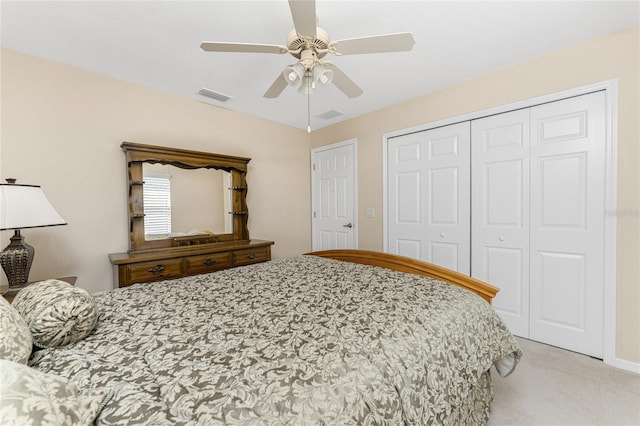 bedroom featuring a closet, ceiling fan, and light carpet