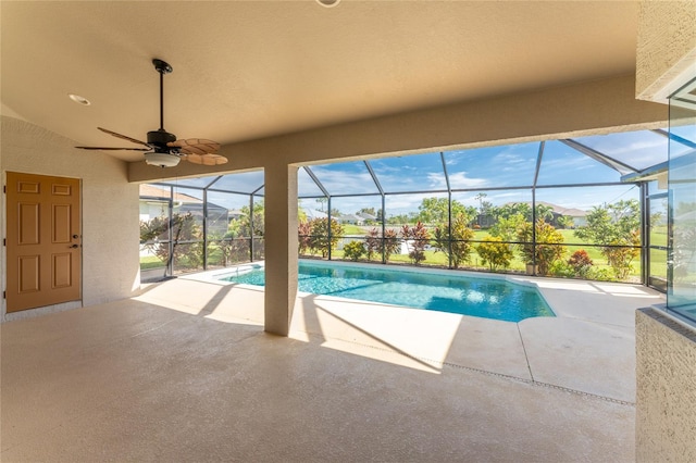 view of pool featuring a lanai, a mountain view, a patio, and ceiling fan