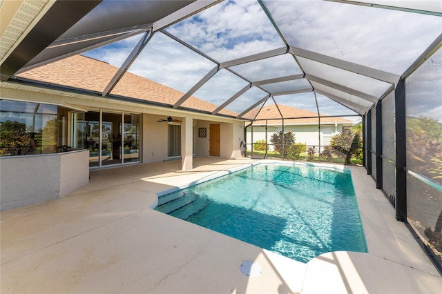 view of pool featuring a patio, ceiling fan, and glass enclosure