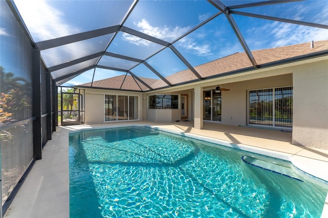 view of pool with ceiling fan, a lanai, and a patio area