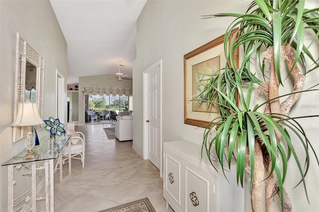hallway with lofted ceiling