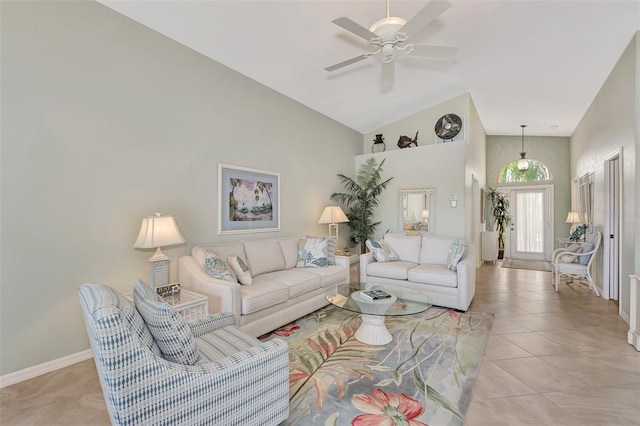 living room featuring light tile patterned floors, high vaulted ceiling, baseboards, and ceiling fan